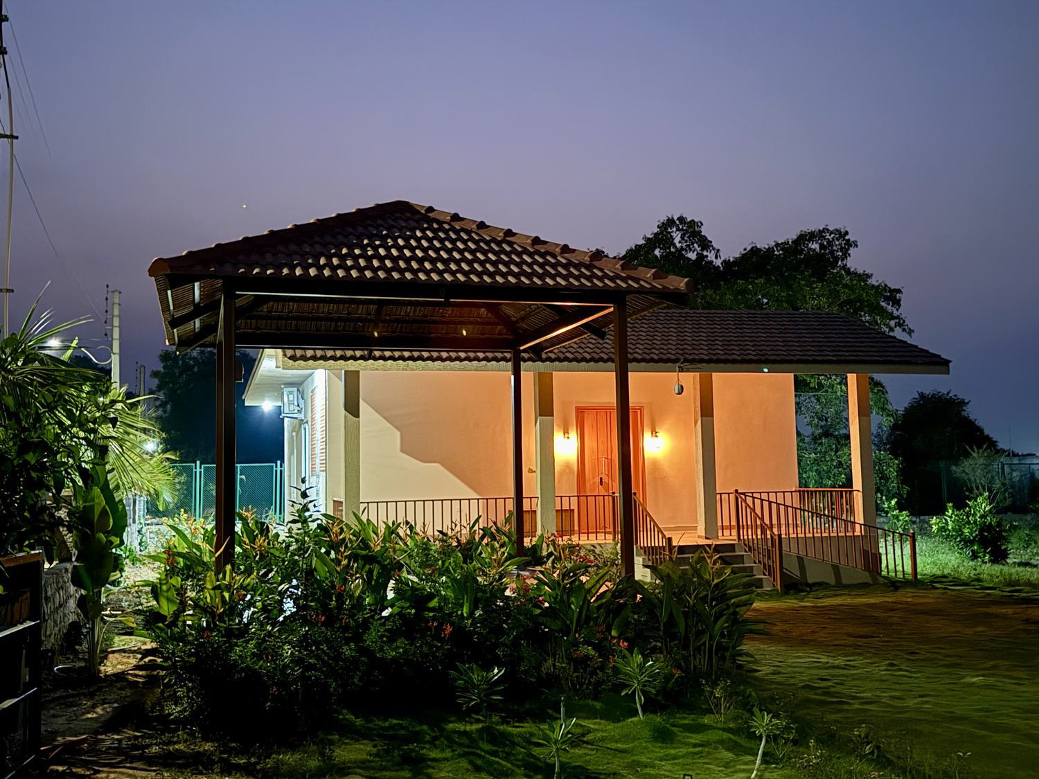 Nature's Nest farmhouse and gazebo glowing at night