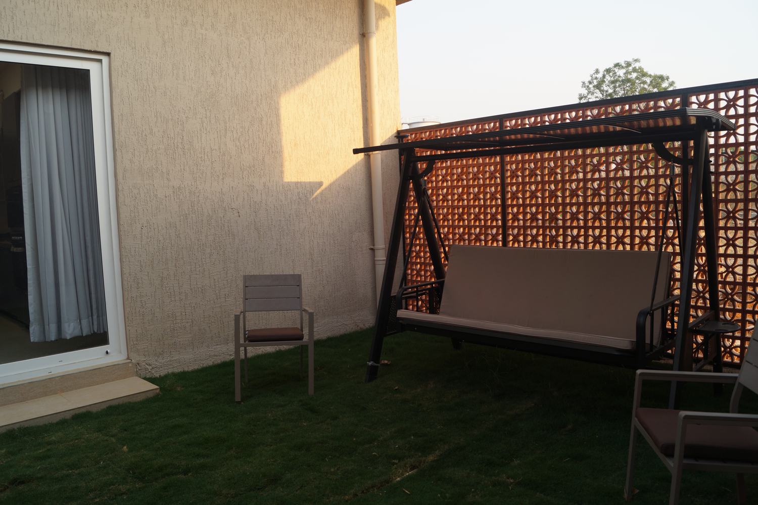Nature's Nest villa lawn with gazebo and farmhouse exterior at golden hour